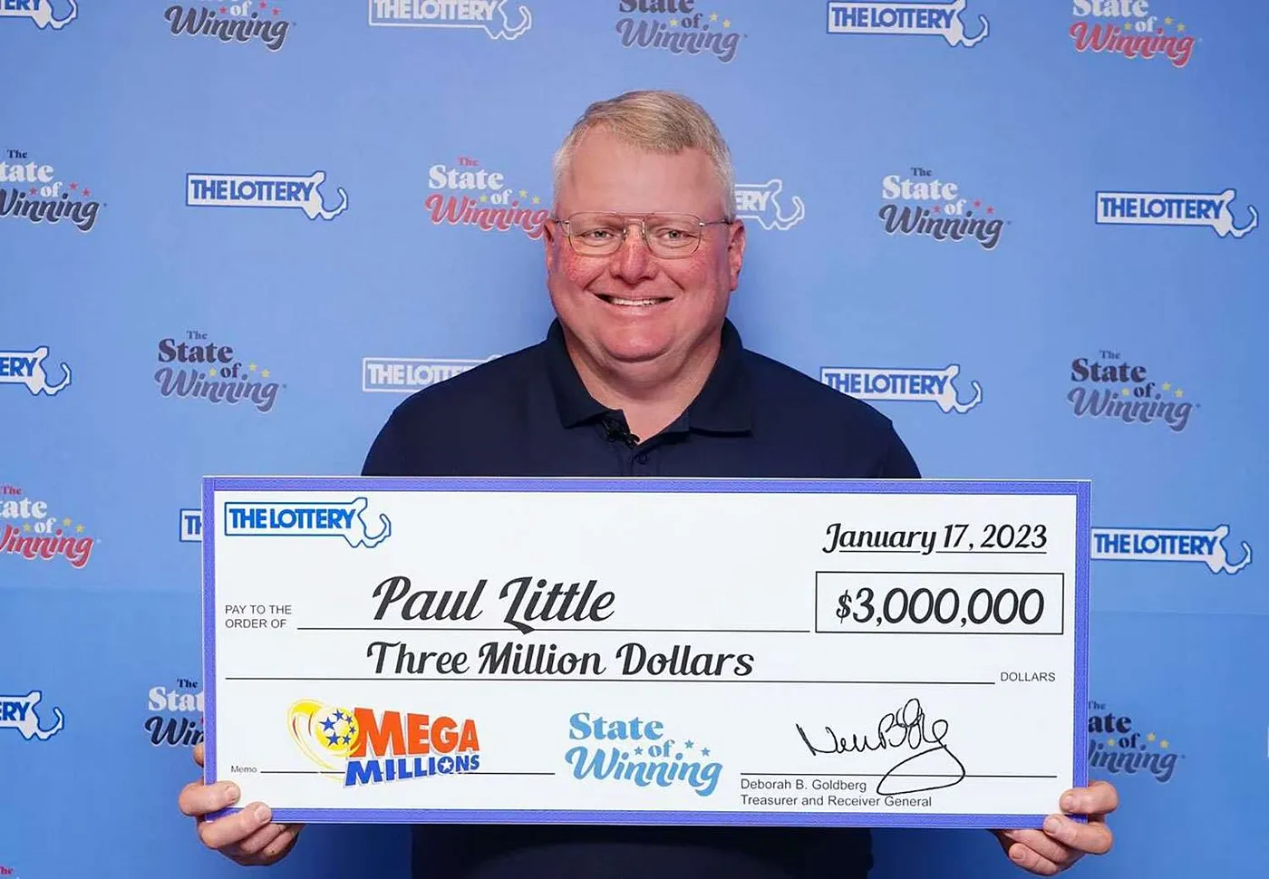 A guy holding a lottery prize
