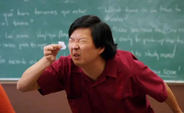 Ken Jeong squinting at a small paper