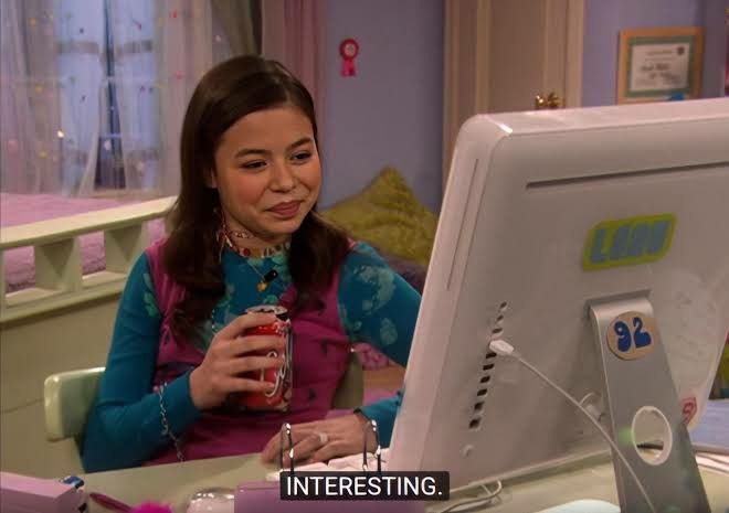Carly from iCarly looking at her PC with the quote 'interesting'